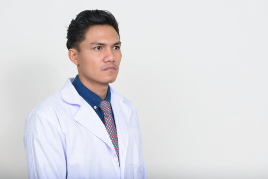 Portrait of handsome Asian man doctor thinking