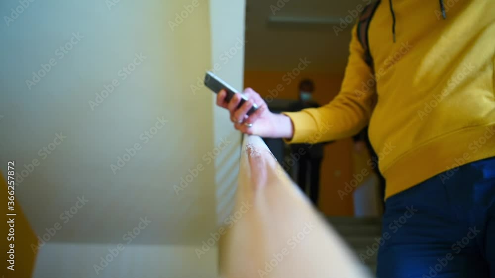 Poster bokeh effect of a man using a phone on the stairs of a building. written communication of people at 
