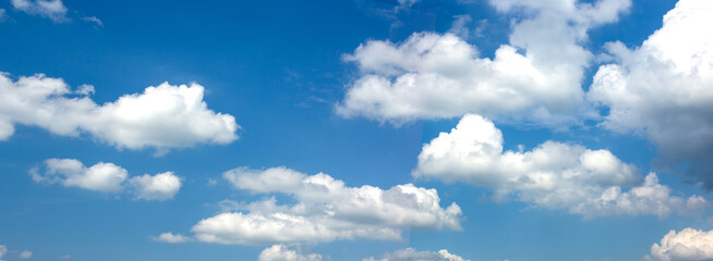 Naklejka na ściany i meble Wide banner with blue sky and white clouds.