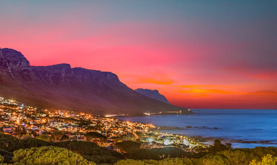 Camps bay illuminated at night with twilight sky in cape town south africa