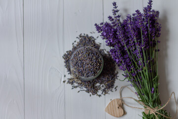 Dried lavender flowers and bouquet on white background, flat lay