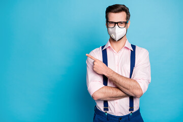 Portrait of his he attractive healthy guy wearing safety respirator n95 mask showing info copy...
