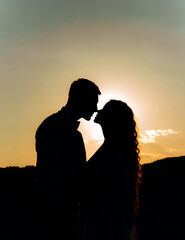 Lovely silhouette of a couple in love at sunset.