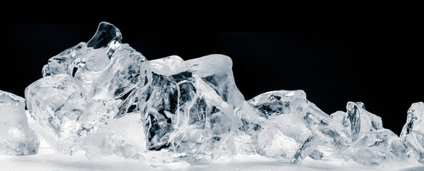 Pieces of crushed pure ice cubes on black background.