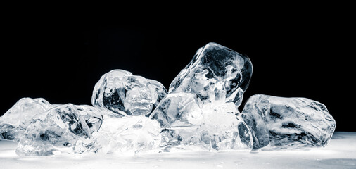 Pieces of crushed ice cubes on black background.