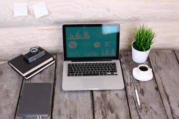 Stylish workspace with computer and posters on home or studio.