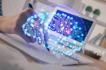 Multi exposure of writing hand on background with brain hologram. Concept of self learning.