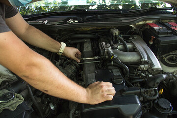mechanic changing car engine