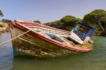 abandoned and sunken fishing boat on the coast of Cadiz, Spain