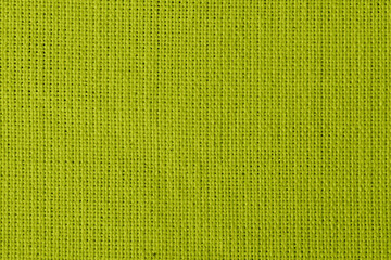 Dark yellow background with checkered pattern, closeup. Structure of the Dark yellow fabric with natural texture. Cloth backdrop.