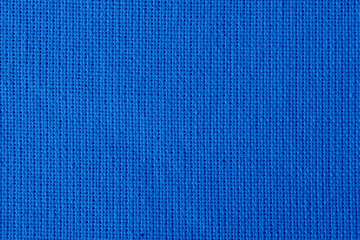 The linen cloth in blue color. Fabric background texture. Detail of textile material close-up.