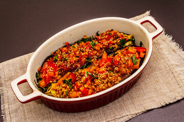 Karniyarik traditional Turkish food from stuffed eggplants with minced meat, tomato, greens and sesame seeds