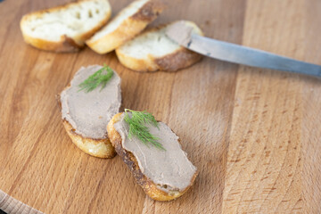 Fresh homemade chicken liver pate on wooden board