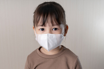 Close-up of a girl wearing a protective mask. New normal health care concepts
