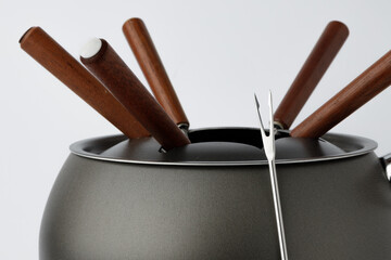 Metal cookware for fondue preparation on white