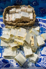 scattered lemon nougat with nuts and candied fruits in individual packaging