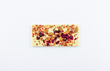 A bar of white chocolate with dried berries, candied fruits and almonds.