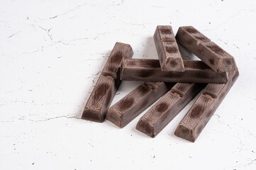 Dark milk chocolate bars stack isolated on a white background