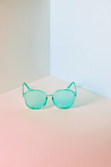 Stylish blue sunglasses on modern minimal pastel background, front view. Nobody. Product photograph