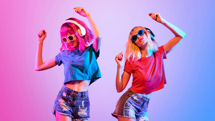 Fashion. Disco party woman have fun dance. Two DJ girl in colorful neon light enjoy music, friends. Party disco 80s 90s neon nightclub vibes. Pop art. Creative fashionable neon style