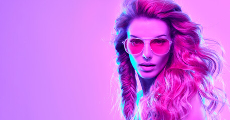 High Fashion. Woman in colorful neon light, make-up. Sexy girl, stylish hair, trendy makeup. Party disco pink purple neon style. Creative art beauty portrait, fashionable model face, make up