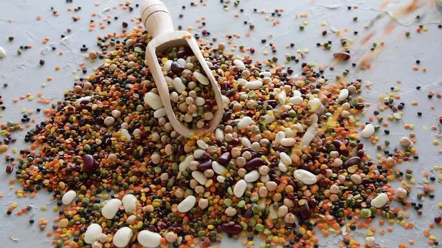 Beans and lentils pouring on table