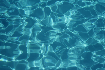 Swimming pool water texture in abstract style on blue background. Vacation, holiday. Ripple water. Watercolour abstract texture. Swimming pool water sun reflection background. Summer vacation.
