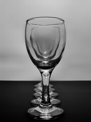 Row of empty wine glasses on table. Black and white concept