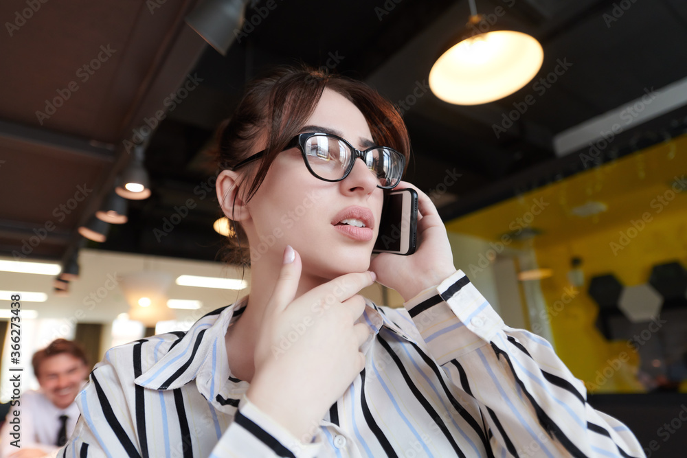 Poster portrait of businesswoman with glasses using mobile phone