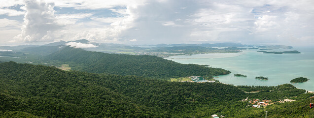 Fototapeta premium Landscape Panorama over the Island of Langkawi, Malaysia At the sky bridge in the north of Langkawi, Malaysia. Panorama landscape on a cloudy day over the shore of the small malaysian island