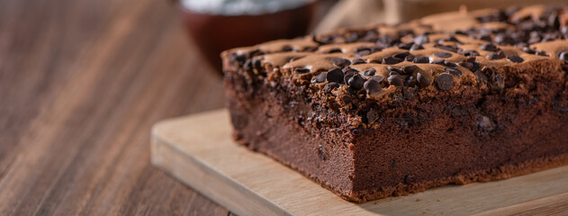 Chocolate flavor Taiwanese traditional sponge cake (Taiwanese castella kasutera) on a wooden tray background table with ingredients, close up.