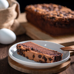 Chocolate flavor Taiwanese traditional sponge cake (Taiwanese castella kasutera) on a wooden tray background table with ingredients, close up.