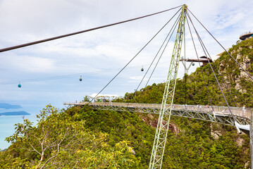 Fototapeta na wymiar The sky bridge in the north of Langkawi, Malaysia. The landmark of the small Malaysian Island. One pillar and 12 cable holding the bridge over the valley. A breathtaking view over the Andaman Sea 