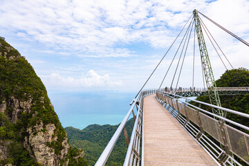 Obraz premium The sky bridge in the north of Langkawi, Malaysia. The landmark of the small Malaysian Island. One pillar and 12 cable holding the bridge over the valley. A breathtaking view over the Andaman Sea 