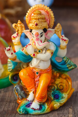 Colorful Painted Handcrafted Statue Of Indian Hindu Lord God Idol Ganesha Ganpati Made Of Earthenware Mud Clay Stone Or Rock For Worship Pooja Puja In Deepawali Deepavali Diwali And Chaturthi Festival