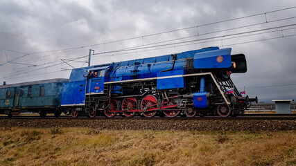 old steam locomotive in operation with wagons