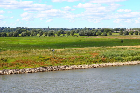 De river IJssel and view from the bridge in Dutch city Doesburg, into the direction of the church of the village Olburgen and Dieren.