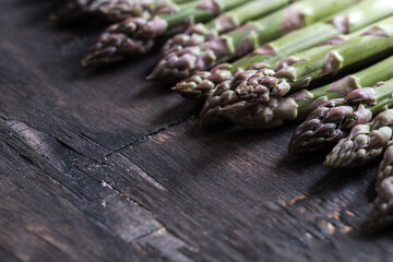 green Asparagus. Bunches of green asparagus on a wooden rustic background