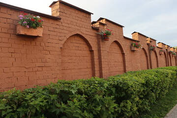 cemetery brick wall with flowers