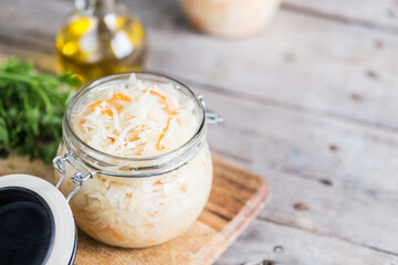 Sauerkraut fermented salad. Homemade fresh pickled cabbage (german sauerkraut) with ingredients in jar