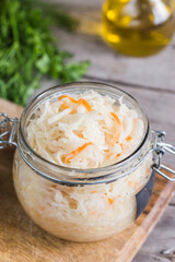 Sauerkraut fermented salad. Homemade fresh pickled cabbage (german sauerkraut) with ingredients in jar