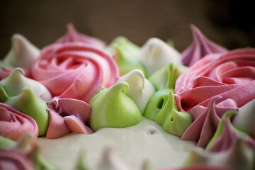 decoration of meringue cake in the form of curls and roses