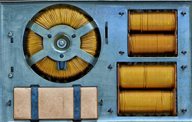 copper transformer capacitor stabilizer on a blue metal slab