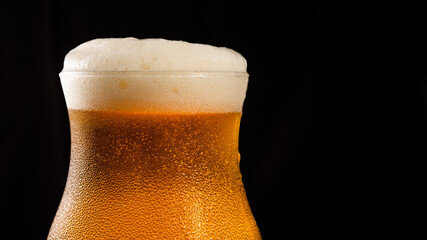 Close up top of the wine with foam, dark background and copy space