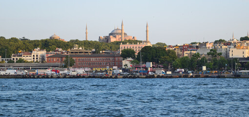 Hagia Sophia (Aya Sophia), Christian greek-orthodox patriarchal basilica, imperial mosque and museum, Istanbul, Turkey - view from Golden Horn to the Eminonu ferry quay.  - obrazy, fototapety, plakaty