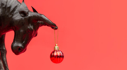 Ox with Christmas ball on horns on red background, banner. Buffalo, bull as symbol of year 2021 to...