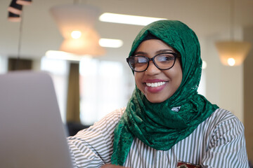 african muslim business woman working on laptop computer