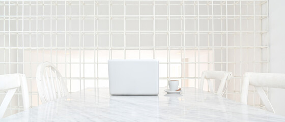 Mock up modern workspace desk and copy space with laptop and coffee cup on white table. Front view. concept work from home.