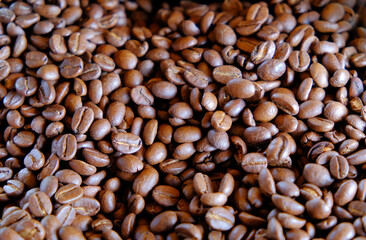 group of  roasted coffee beans, light and shadow on roasted coffee beans background
