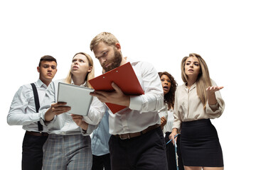 Decisions. Nervous tensioned investors analyzing crisis stock market with charts on their gadgets. Defaulted, crisis of exchange markets and funds. Overly concerned men and women with gadgets, papers.